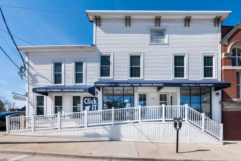 Click IT storefront, a managed IT support provider in a white building with ramp access.